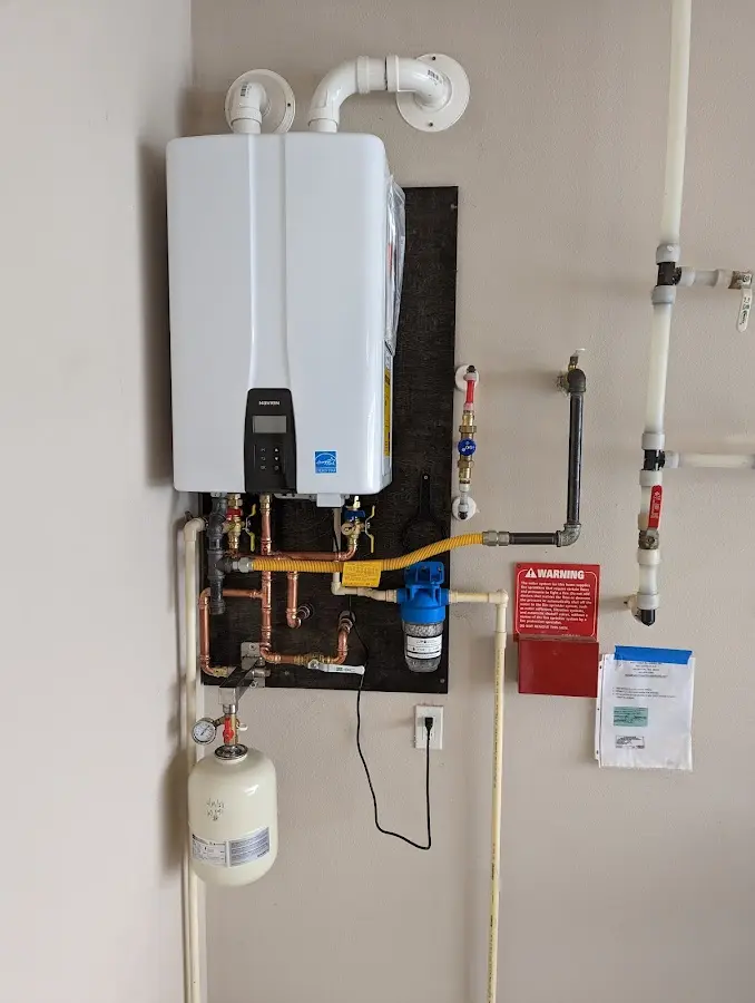 Professional plumber installing copper piping in a Sioux Falls home